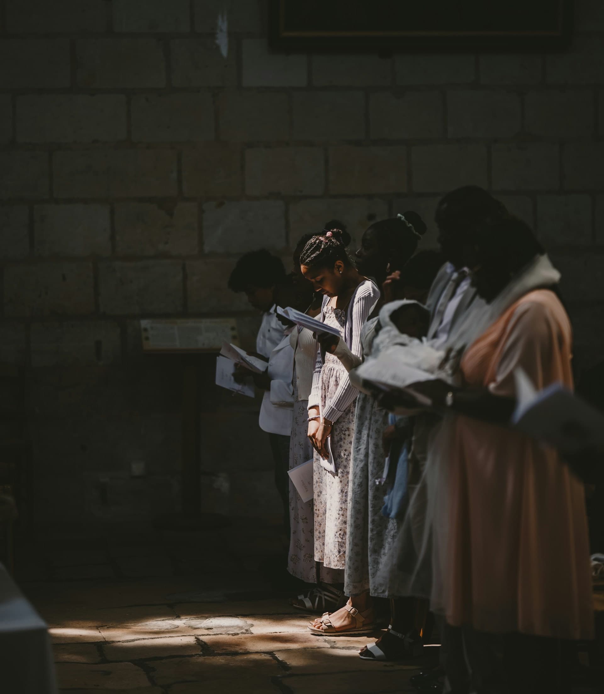 A congregation standing together to pray (stock photograph by Martin Baron)