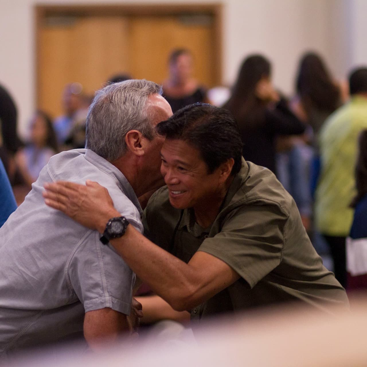 Two people greeting each other warmly after a service (stock photograph by Erika Giraud)
